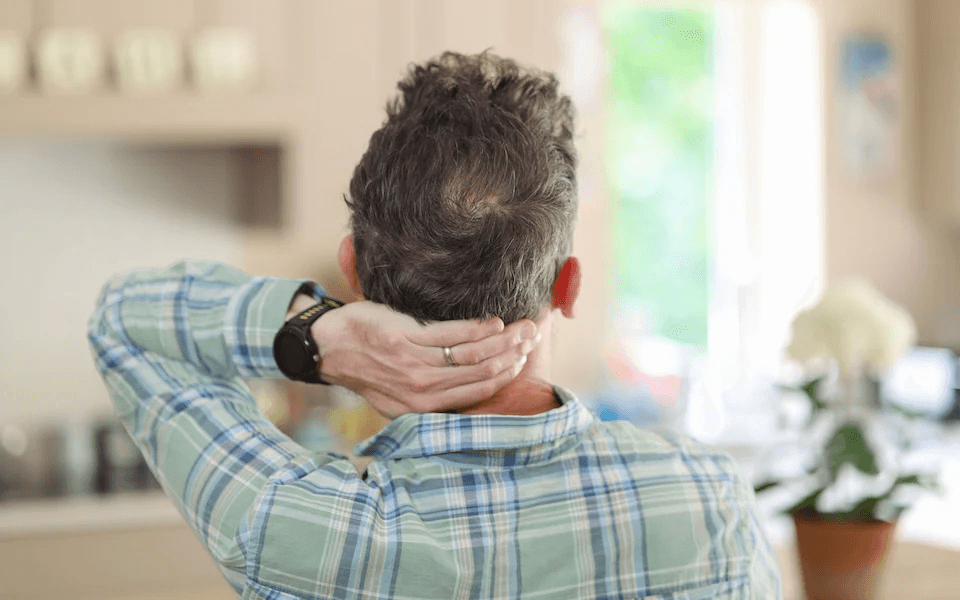 Dom Hogan showing the back of his head after recovery, hands on neck